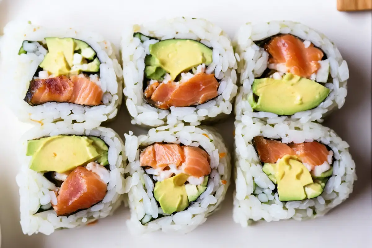 Freshly made Salmon Avocado Roll on a wooden serving board