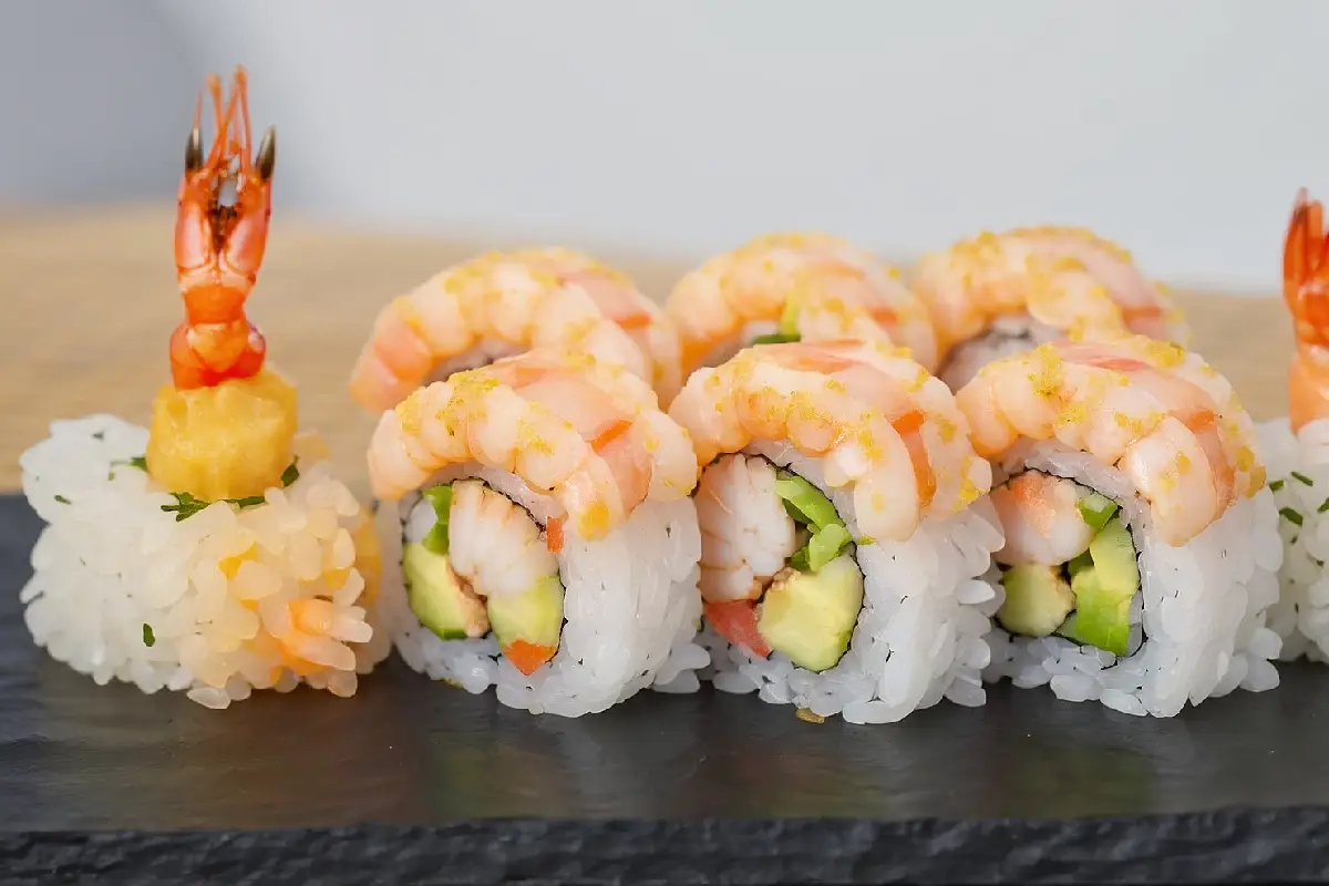 Hand-rolled shrimp sushi on a bamboo mat